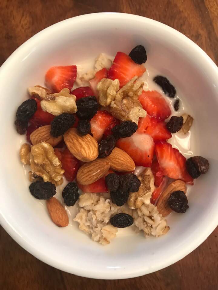 Breakfast bowl of oatmeal with fruits and nuts